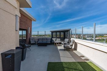 Roof top patio with couch and chairs